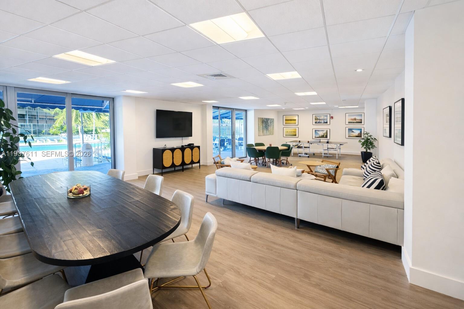 880 Northeast 69th Street, Unit 8M Miami, FL 33138 - Photo 14 of 14 a living room with furniture and a flat screen tv