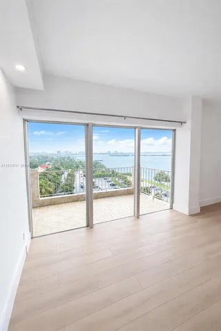 an empty room with large windows and a large window