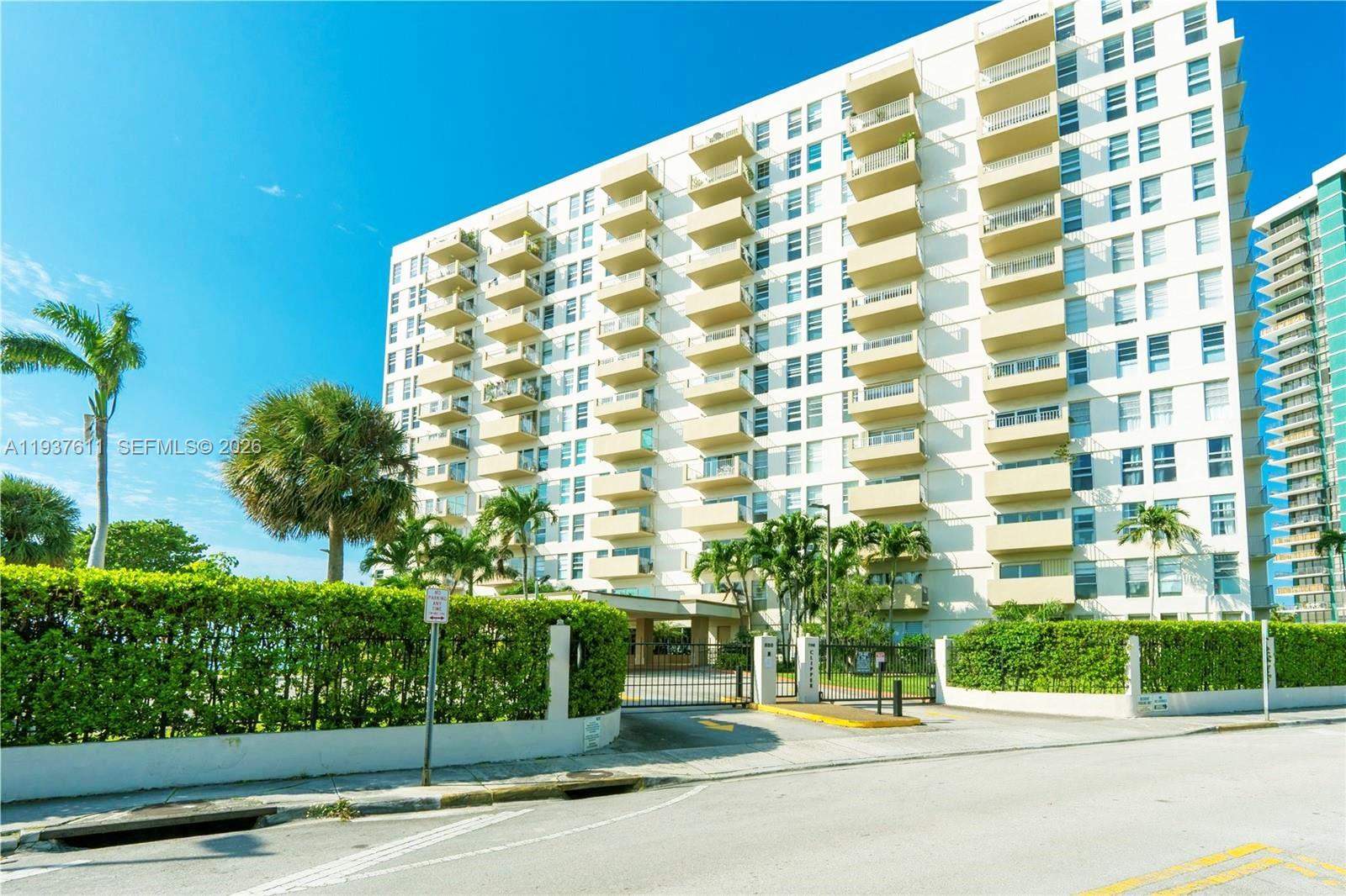 880 Northeast 69th Street, Unit 8M Miami, FL 33138 - Photo 7 of 14 a view of a tall building from a street