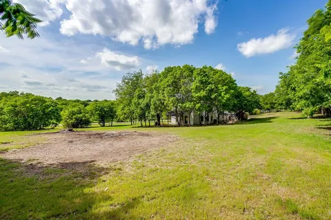 a view of a big yard with an trees