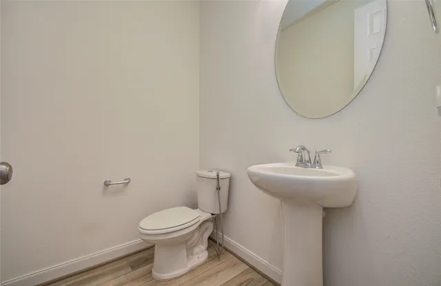a bathroom with a sink a mirror and a toilet