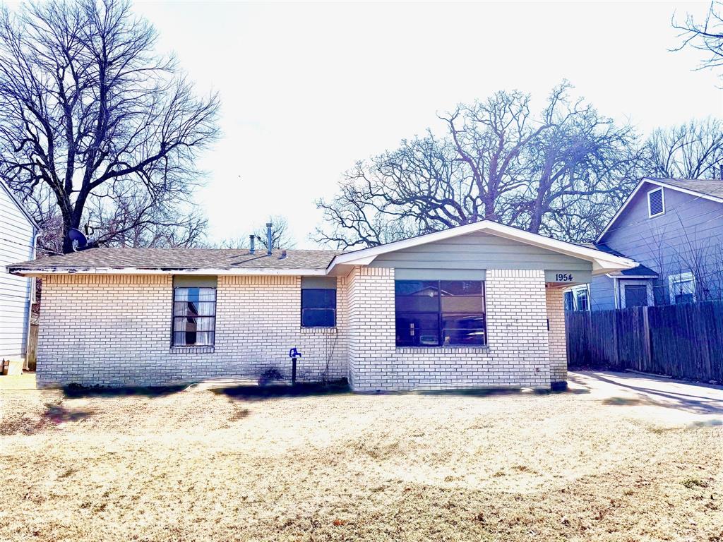 1954 East Booth Street Paris, TX 75460 - Photo 1 of 11 a front view of a house with a yard covered in snow