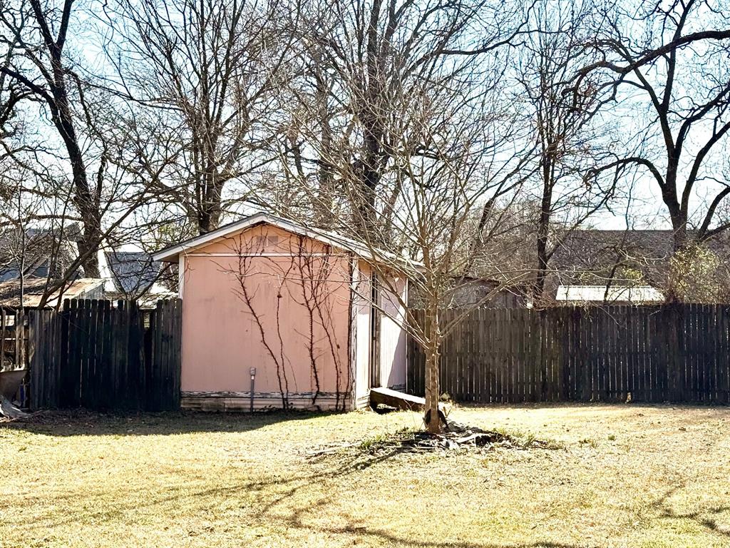 1954 East Booth Street Paris, TX 75460 - Photo 11 of 11 a wooden fence covered with snow in front of house