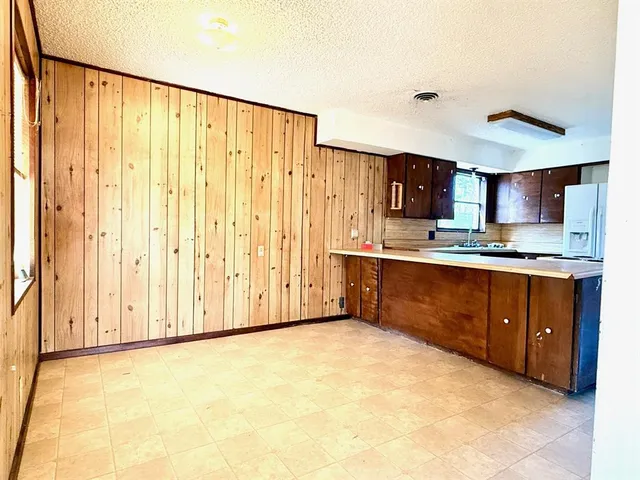 a kitchen with stainless steel appliances granite countertop a stove a sink and a refrigerator with cabinets