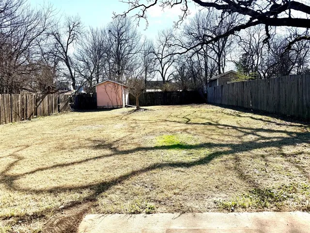a view of outdoor space with wooden fence