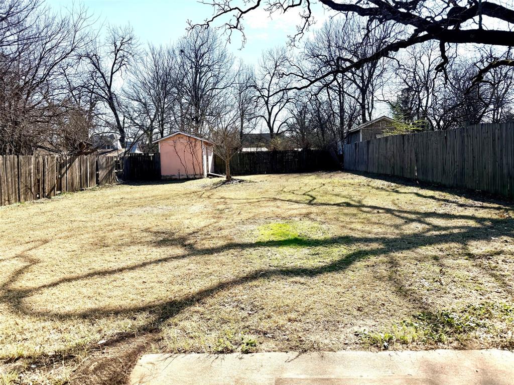 1954 East Booth Street Paris, TX 75460 - Photo 6 of 11 a view of outdoor space with wooden fence