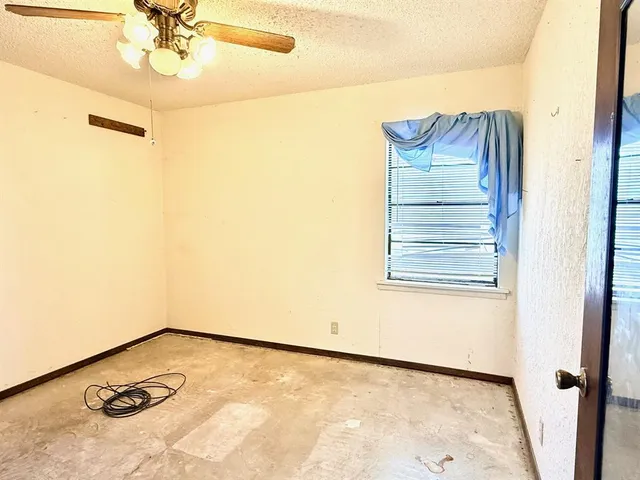 a view of a room with a ceiling fan