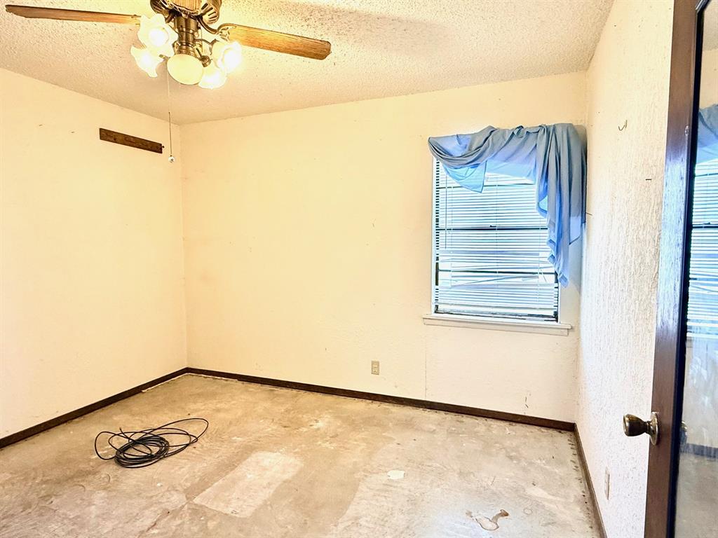 1954 East Booth Street Paris, TX 75460 - Photo 9 of 11 a view of a room with a ceiling fan