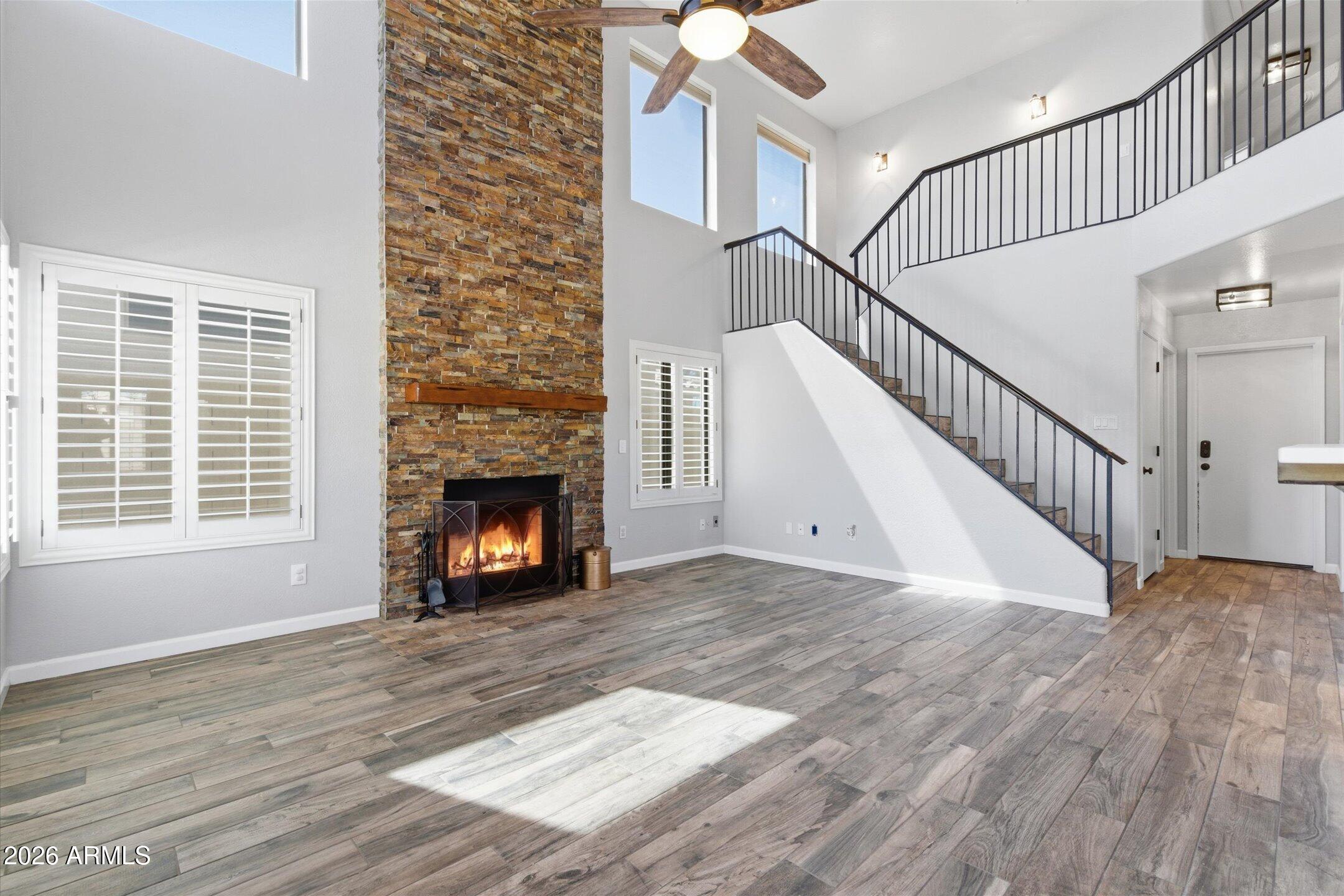 13633 South 47th Street Phoenix, AZ 85044 - Photo 16 of 37 a view of a livingroom with wooden floor a fireplace and window
