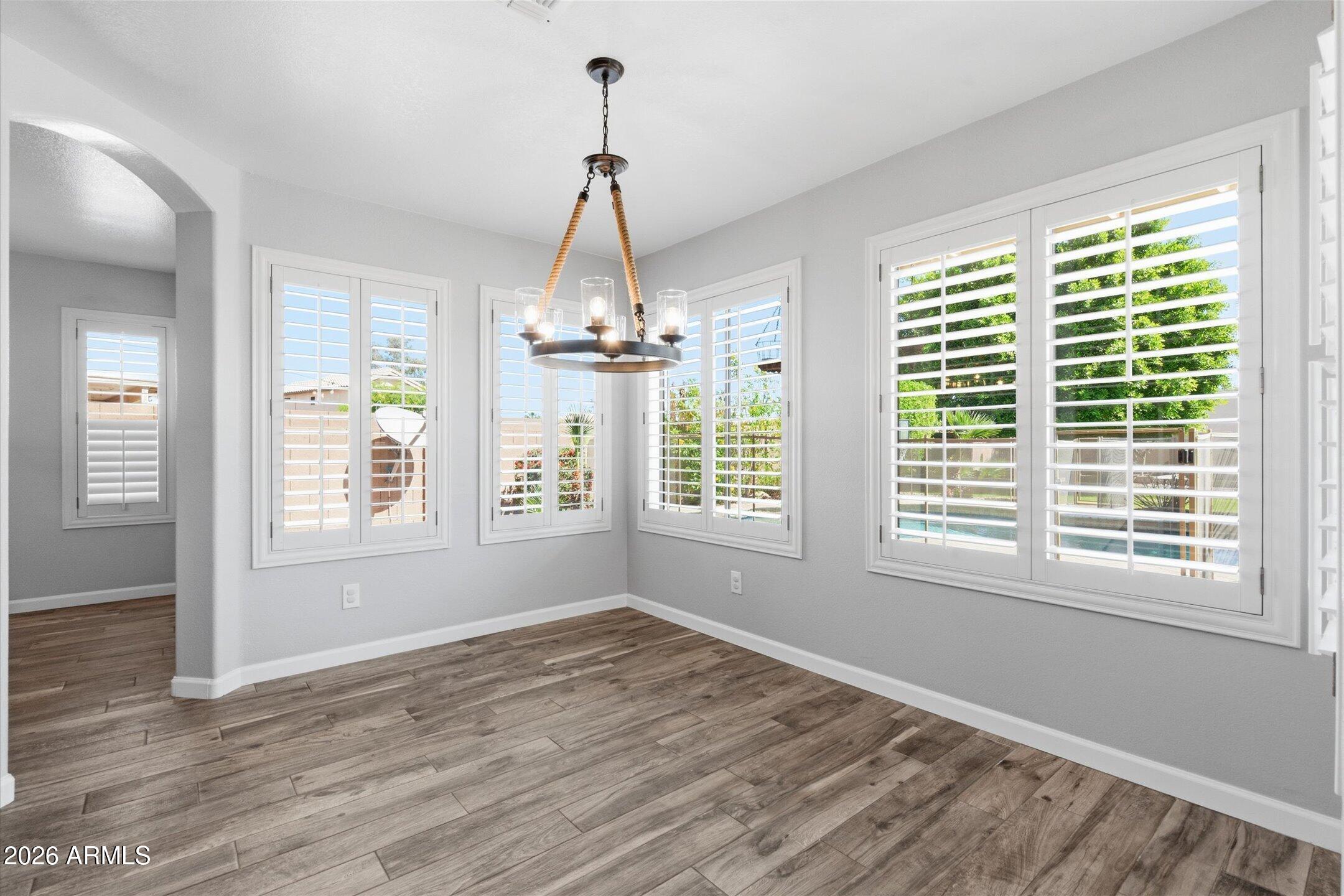 13633 South 47th Street Phoenix, AZ 85044 - Photo 17 of 37 a view of empty room with wooden floor and fan