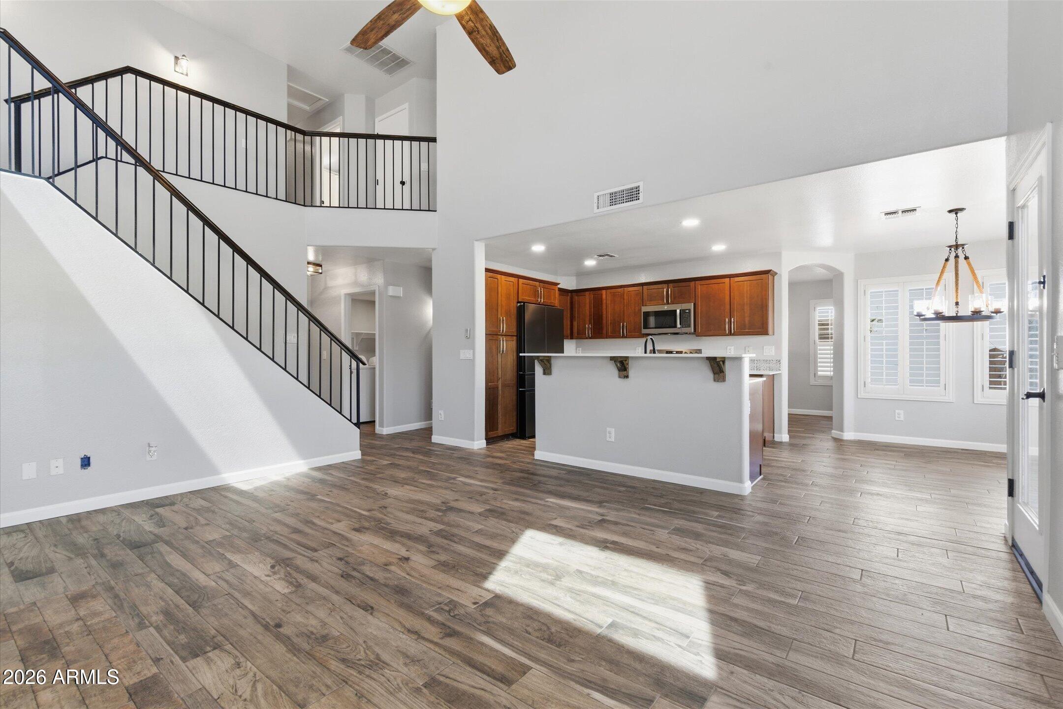 13633 South 47th Street Phoenix, AZ 85044 - Photo 18 of 37 a view of a kitchen with wooden floor and electronic appliances