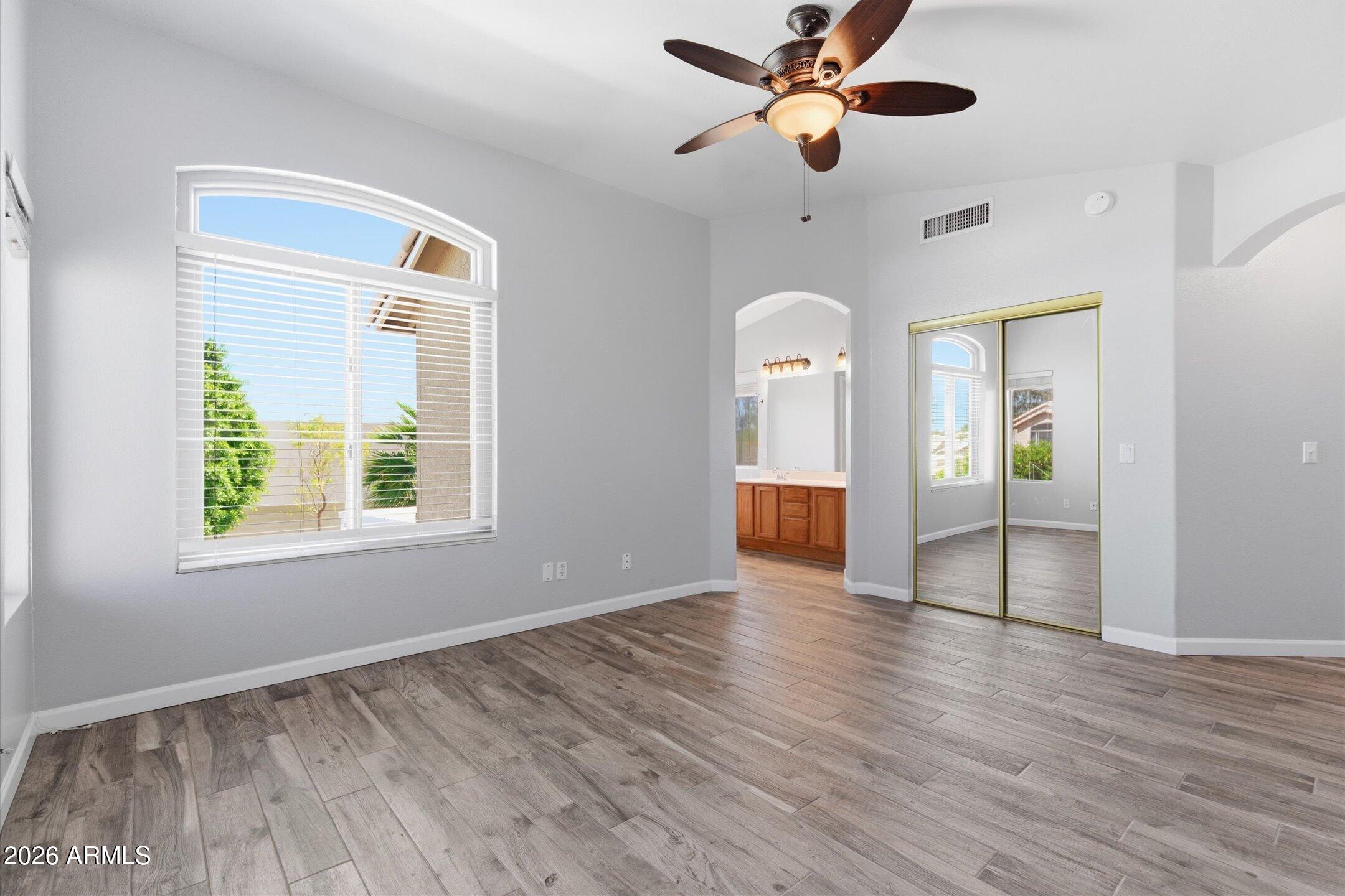 13633 South 47th Street Phoenix, AZ 85044 - Photo 21 of 37 a view of an empty room with window and wooden floor