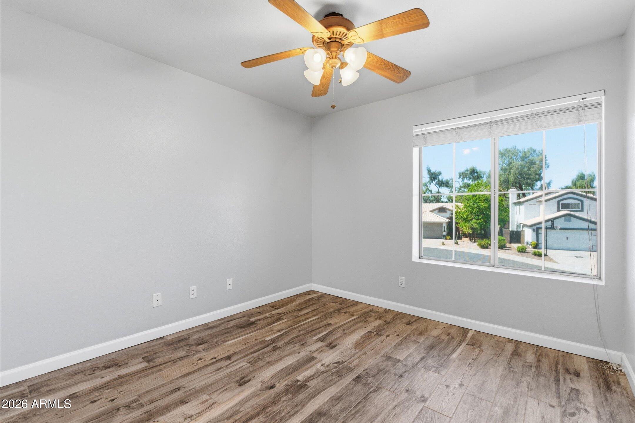 13633 South 47th Street Phoenix, AZ 85044 - Photo 25 of 37 a view of an empty room with wooden floor and a window