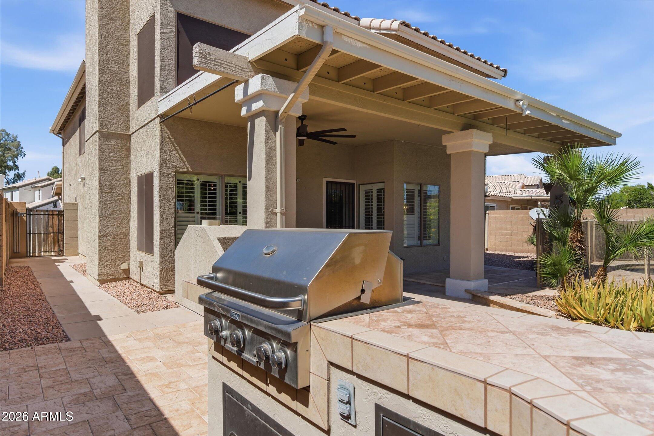 13633 South 47th Street Phoenix, AZ 85044 - Photo 31 of 37 a view of a patio with a table and chairs under an umbrella