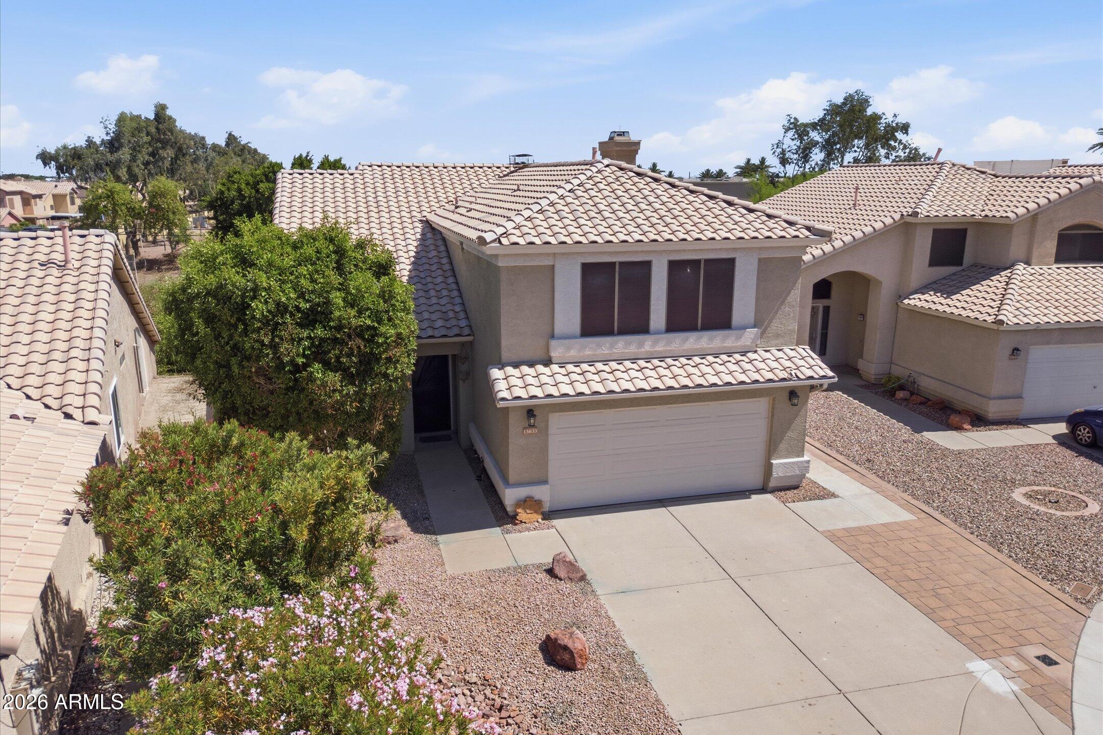 13633 South 47th Street Phoenix, AZ 85044 - Photo 3 of 37 a front view of a house with a garden