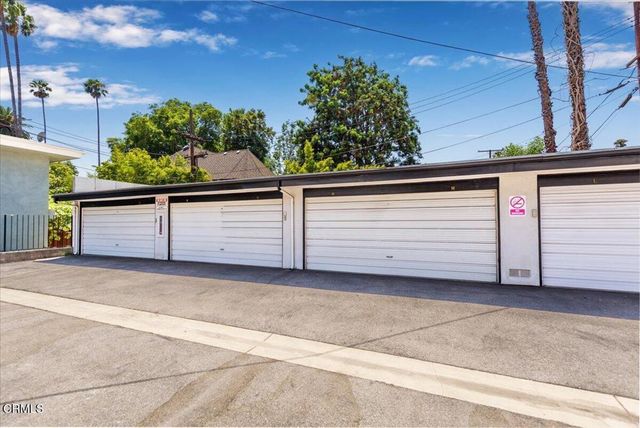 a view of a hallway with cabinets