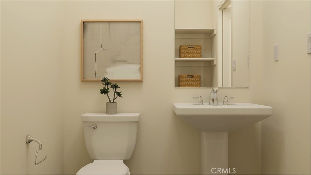1123 Thunderchief Lane Rialto, CA 92376 - Photo 13 of 20 a bathroom with a toilet sink and mirror