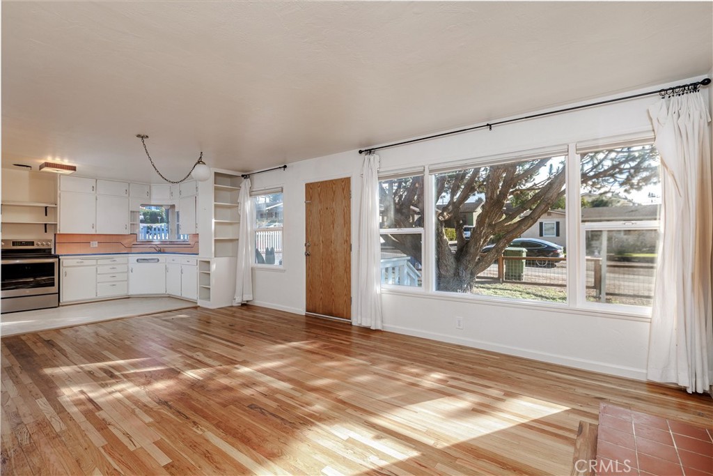 943 Pecho Street Morro Bay, CA 93442 - Photo 5 of 19 a view of a big room with wooden floor and windows