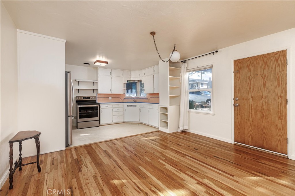 943 Pecho Street Morro Bay, CA 93442 - Photo 7 of 19 a large kitchen with cabinets wooden floor and stainless steel appliances