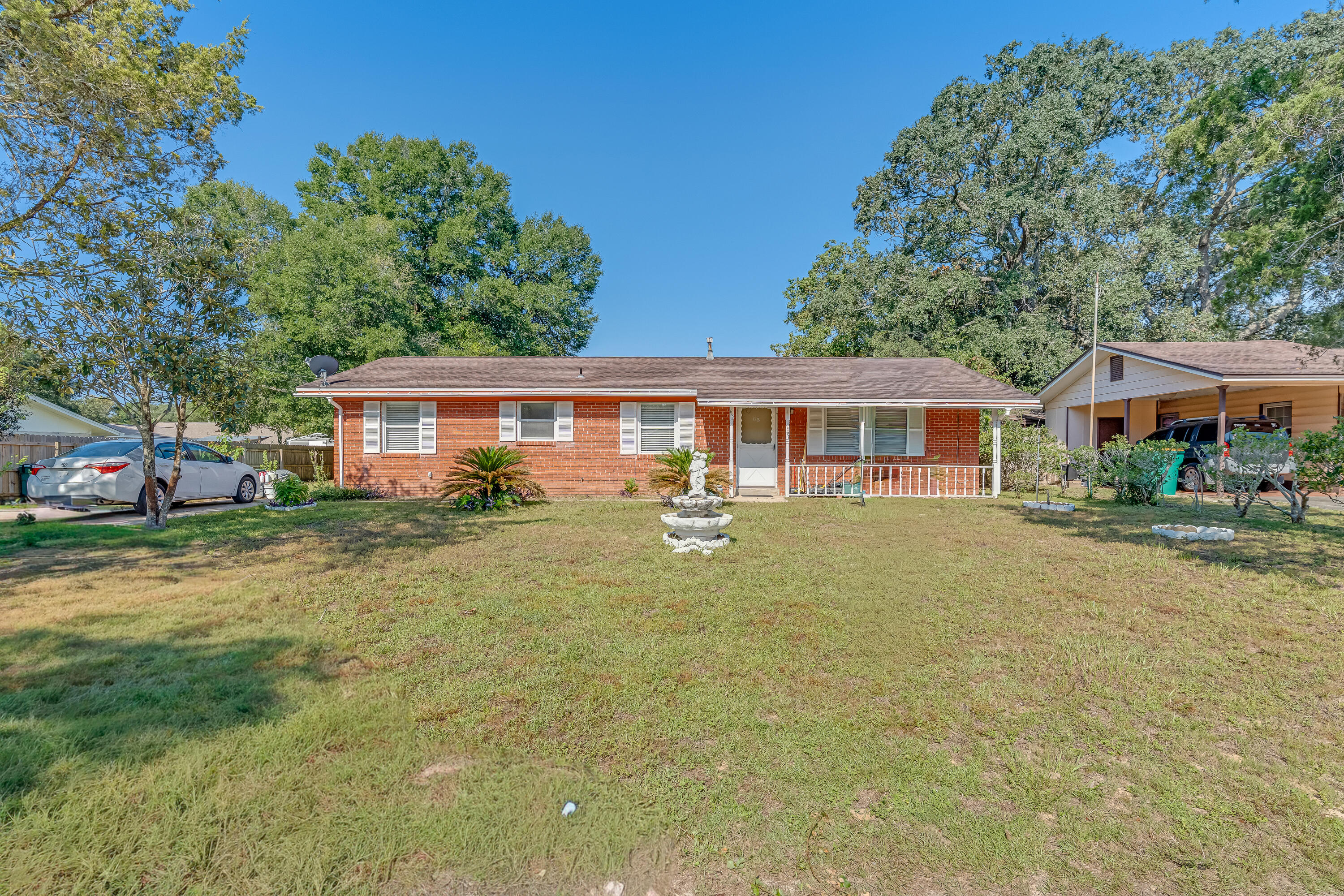 a front view of a house with a yard table and chairs