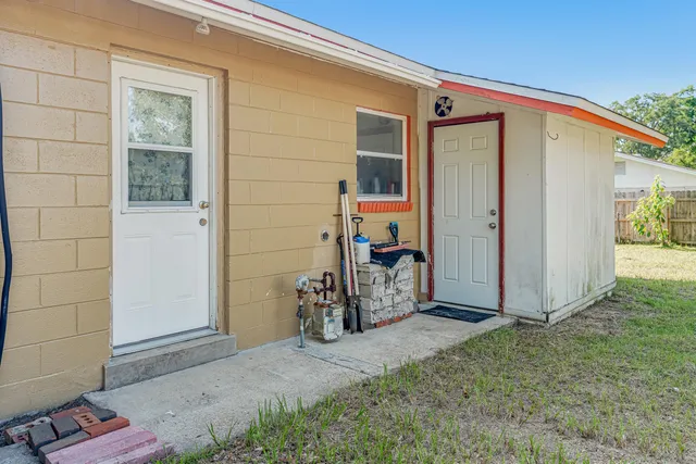 a view of front door and small yard