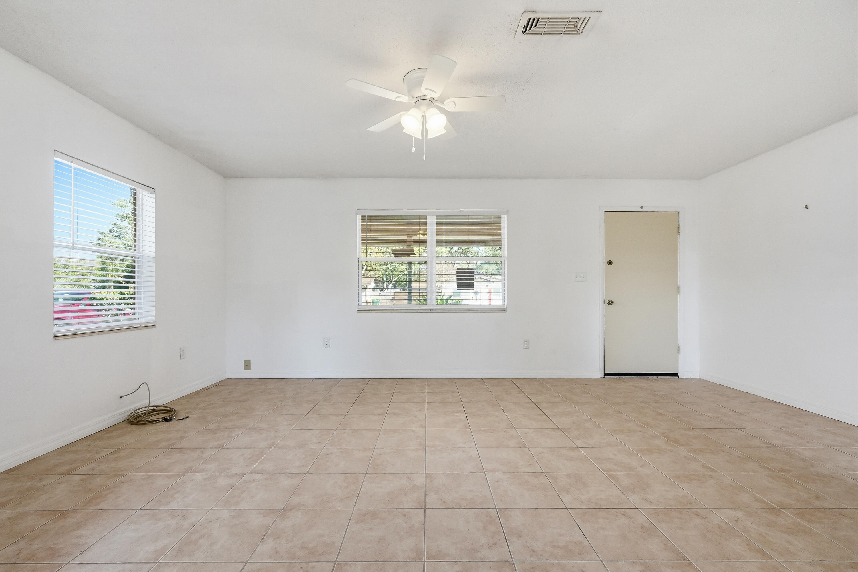 63 Oak Lane Shalimar, FL 32579 - Photo 12 of 42 an empty room with windows and fan