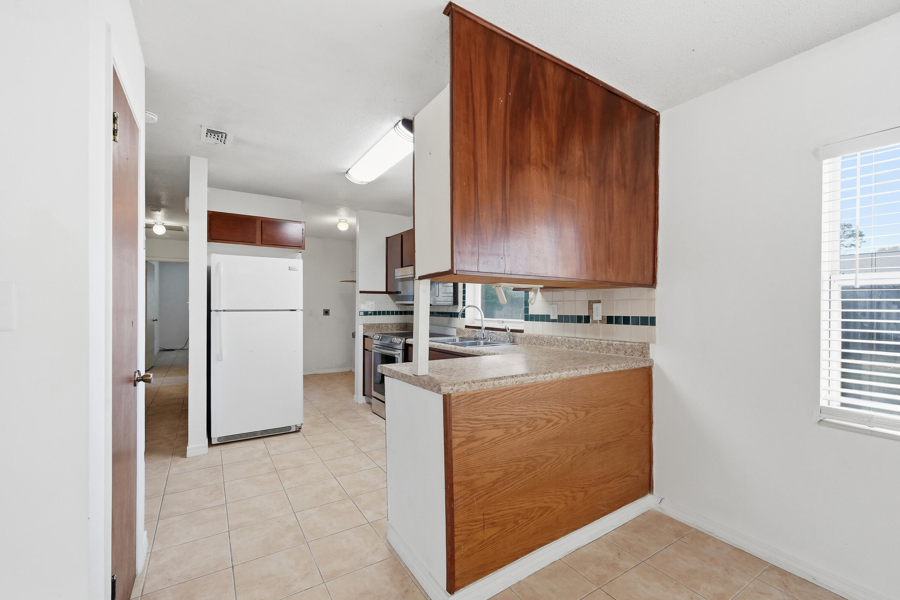63 Oak Lane Shalimar, FL 32579 - Photo 13 of 42 a kitchen with stainless steel appliances granite countertop a refrigerator and a stove