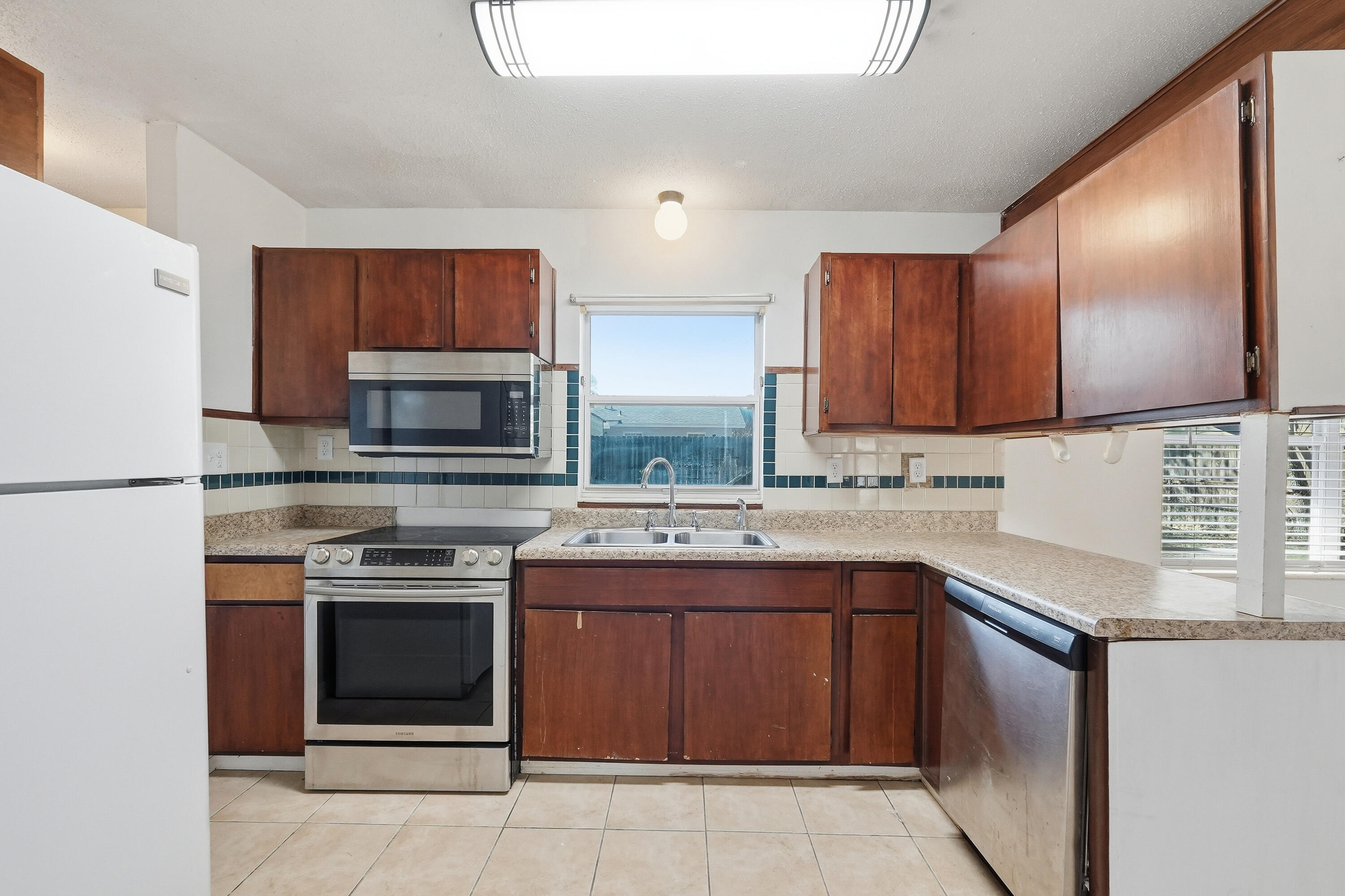 63 Oak Lane Shalimar, FL 32579 - Photo 15 of 42 a kitchen with a sink stove top oven and microwave