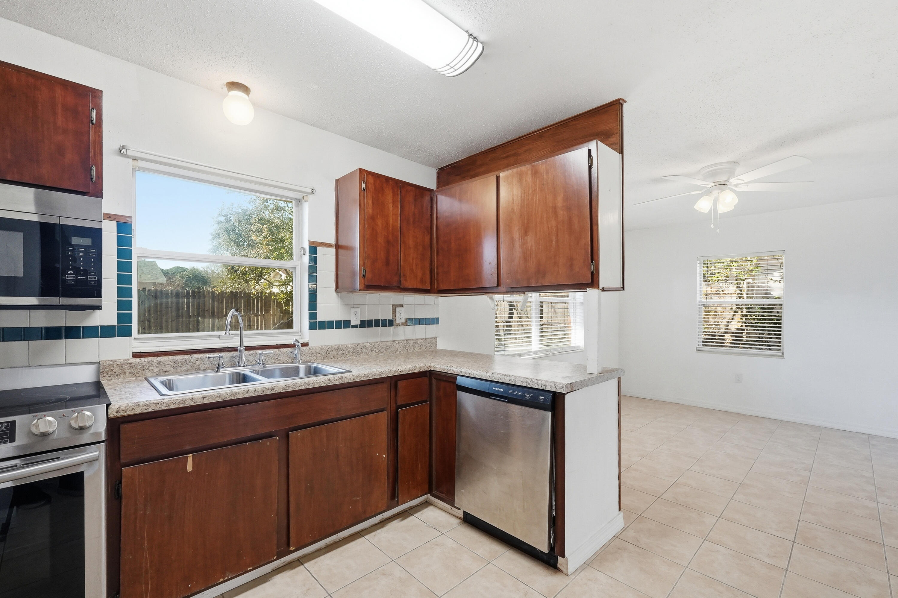 63 Oak Lane Shalimar, FL 32579 - Photo 16 of 42 a kitchen with a sink window and cabinets