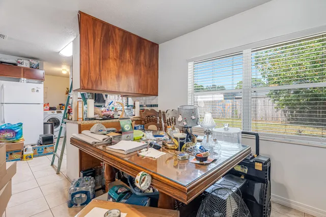 a living room with lots of furniture and clutter