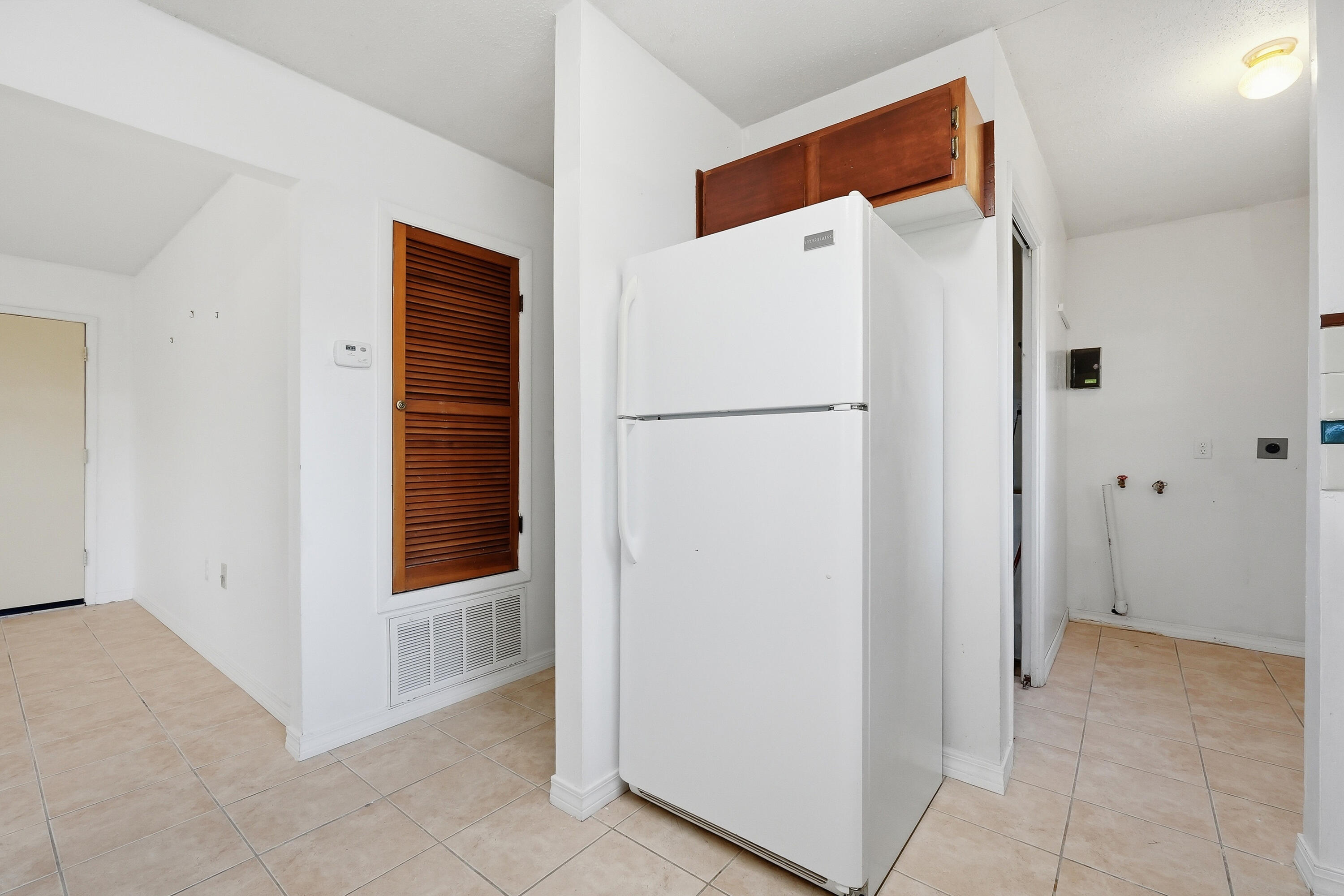 63 Oak Lane Shalimar, FL 32579 - Photo 18 of 42 a white refrigerator freezer and a stove sitting inside of a kitchen