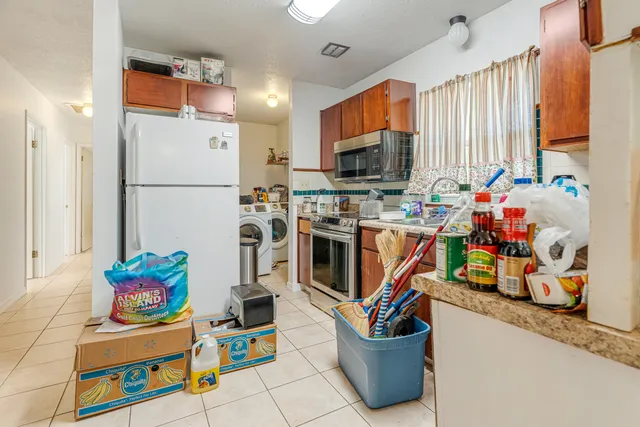 a kitchen with stainless steel appliances a stove a sink dishwasher and a microwave