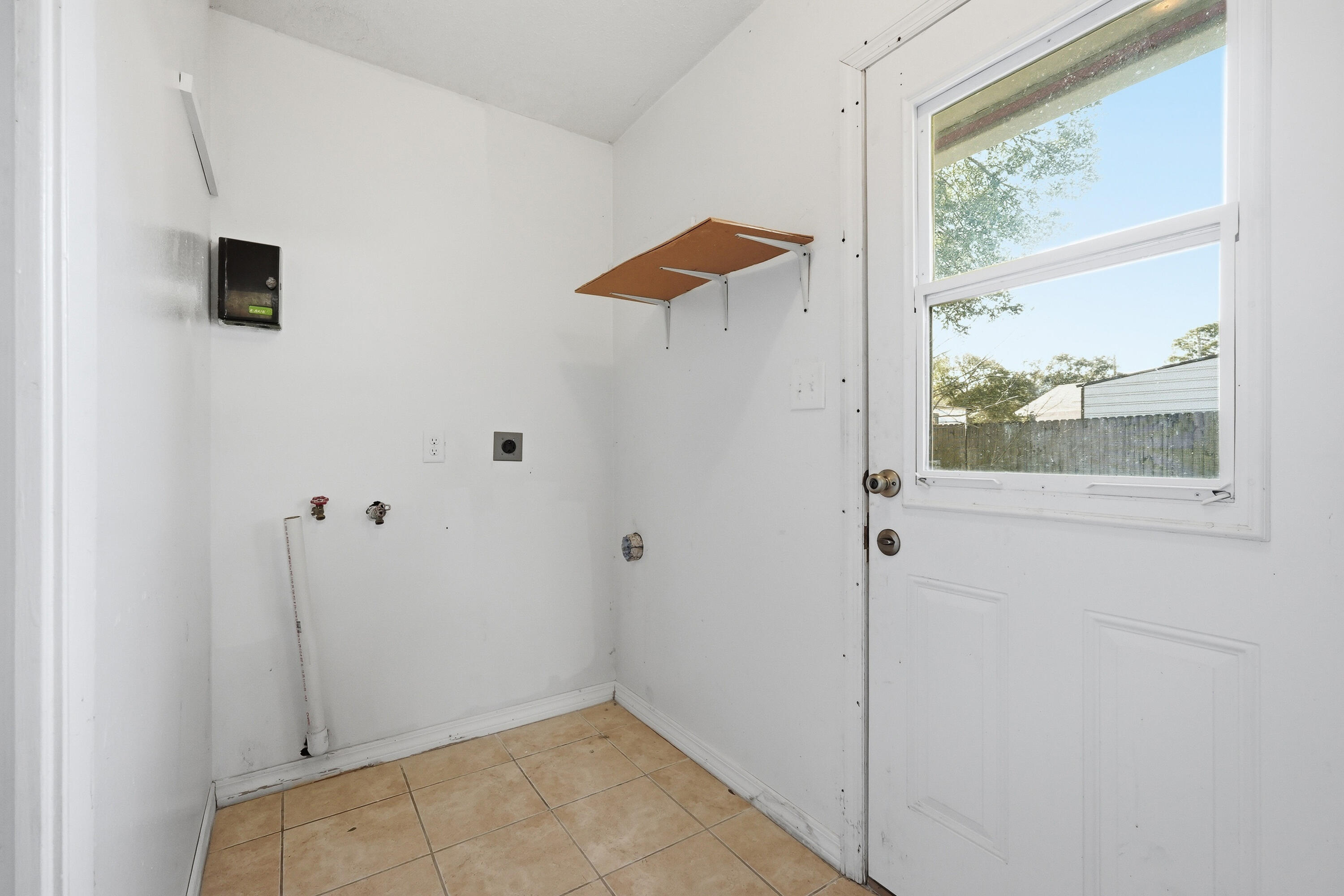 63 Oak Lane Shalimar, FL 32579 - Photo 19 of 42 a view of a small space with wooden floor and a window