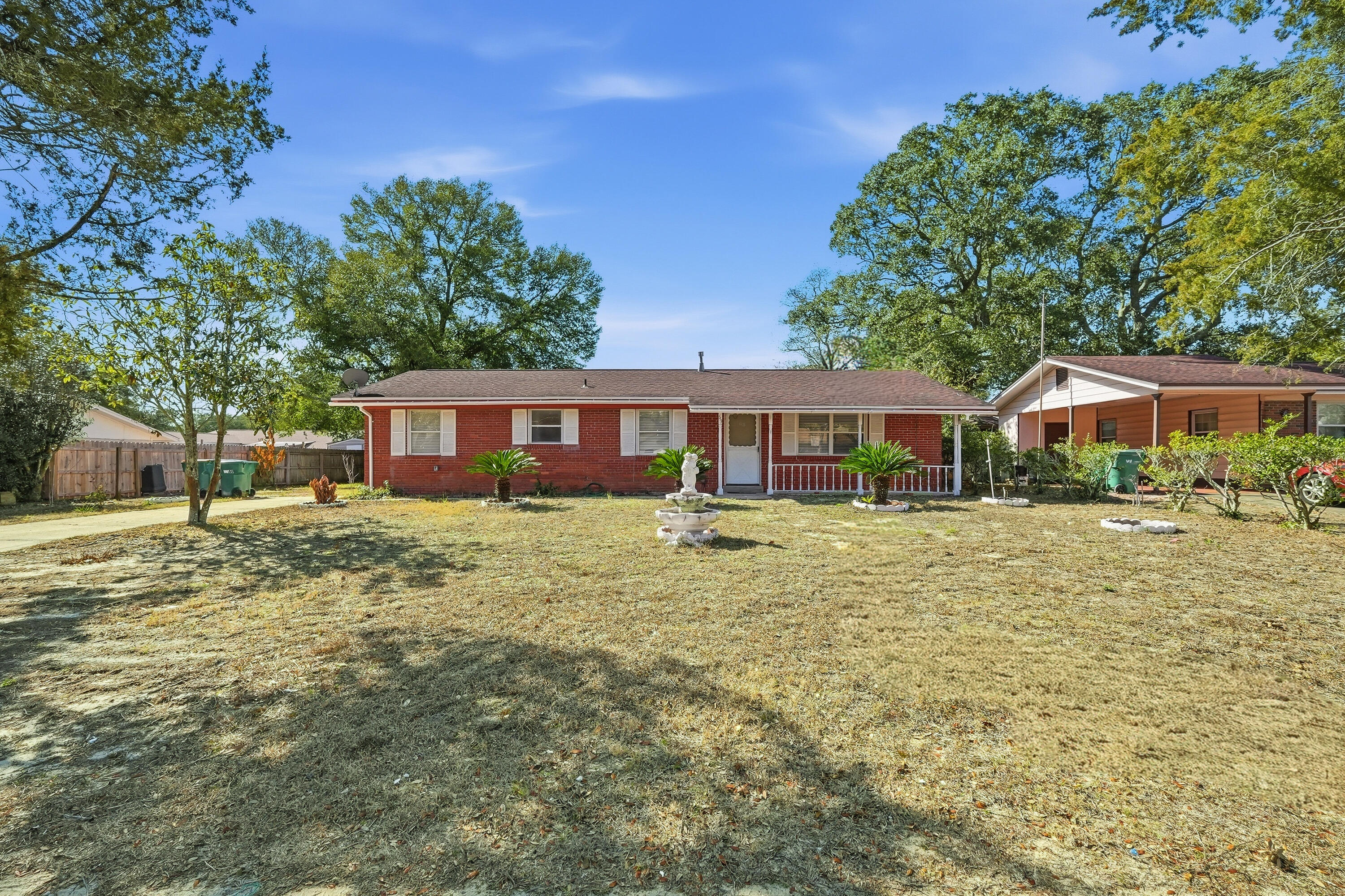 63 Oak Lane Shalimar, FL 32579 - Photo 2 of 42 a front view of a house with a yard