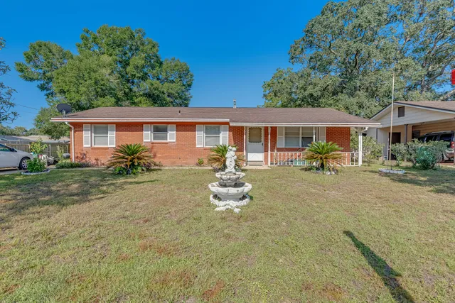 a front view of a house with a garden and patio