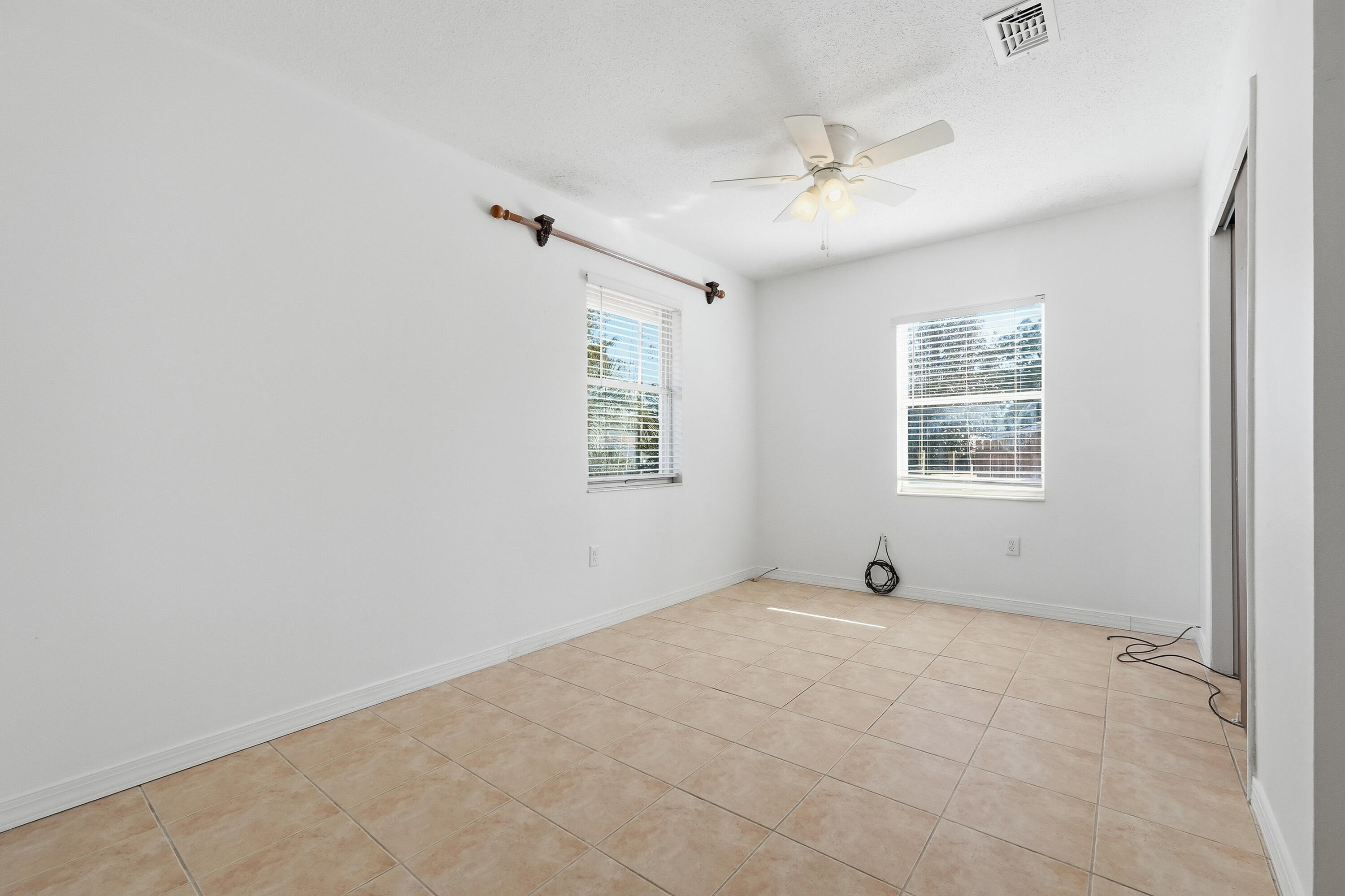 63 Oak Lane Shalimar, FL 32579 - Photo 26 of 42 an empty room with windows and ceiling fan