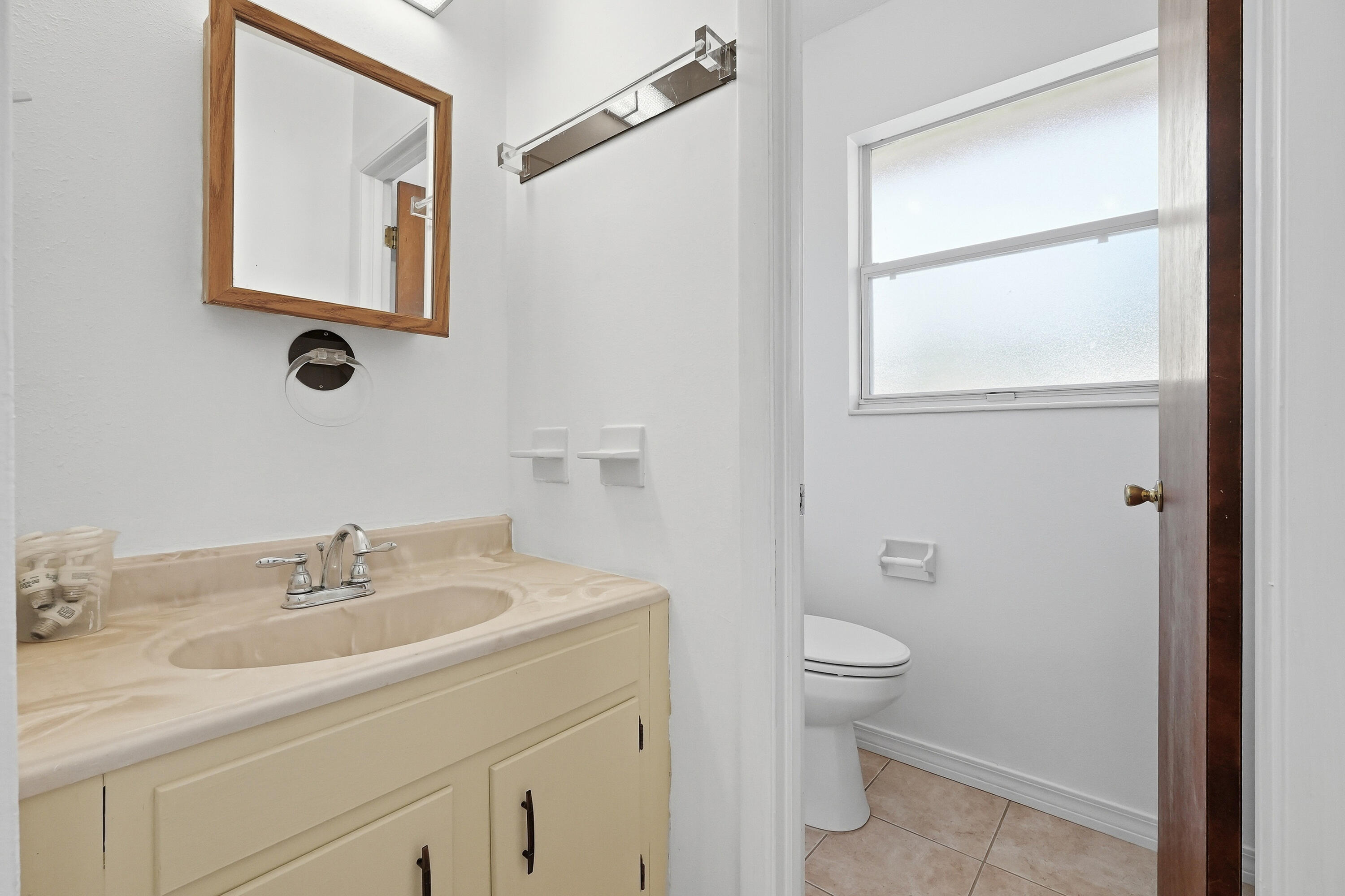 63 Oak Lane Shalimar, FL 32579 - Photo 29 of 42 a bathroom with a granite countertop sink toilet and a mirror