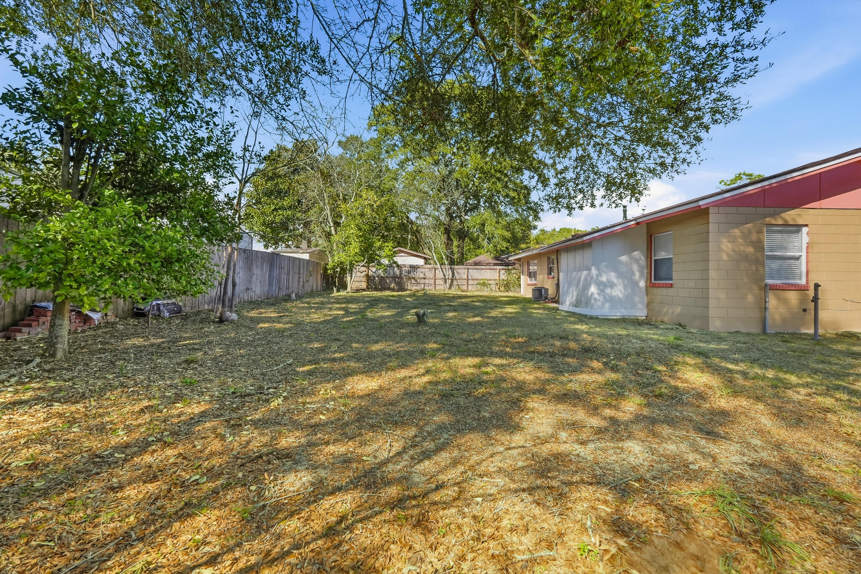 63 Oak Lane Shalimar, FL 32579 - Photo 36 of 42 a view of a backyard with large trees and wooden fence