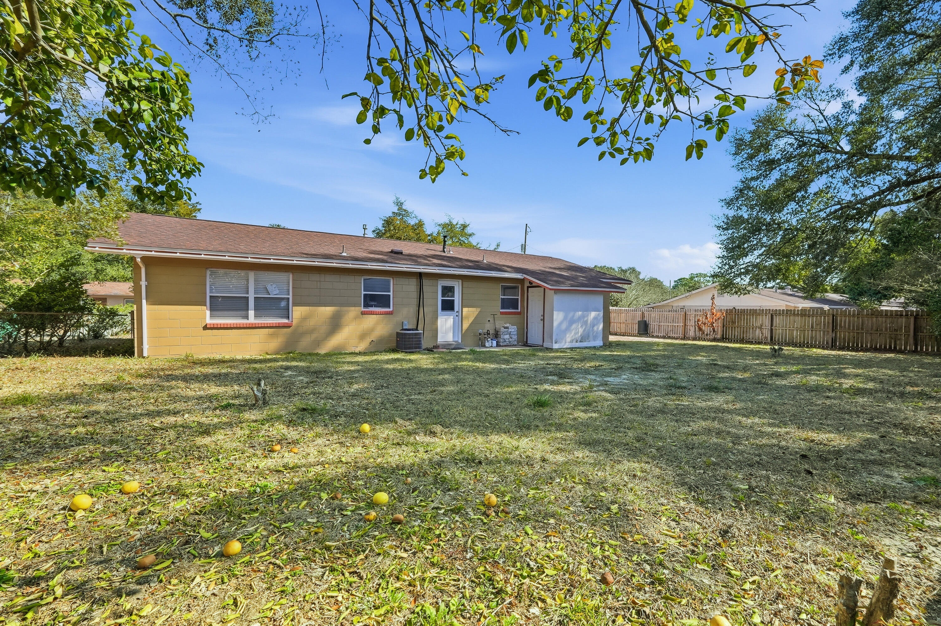 63 Oak Lane Shalimar, FL 32579 - Photo 39 of 42 a front view of a house with a garden