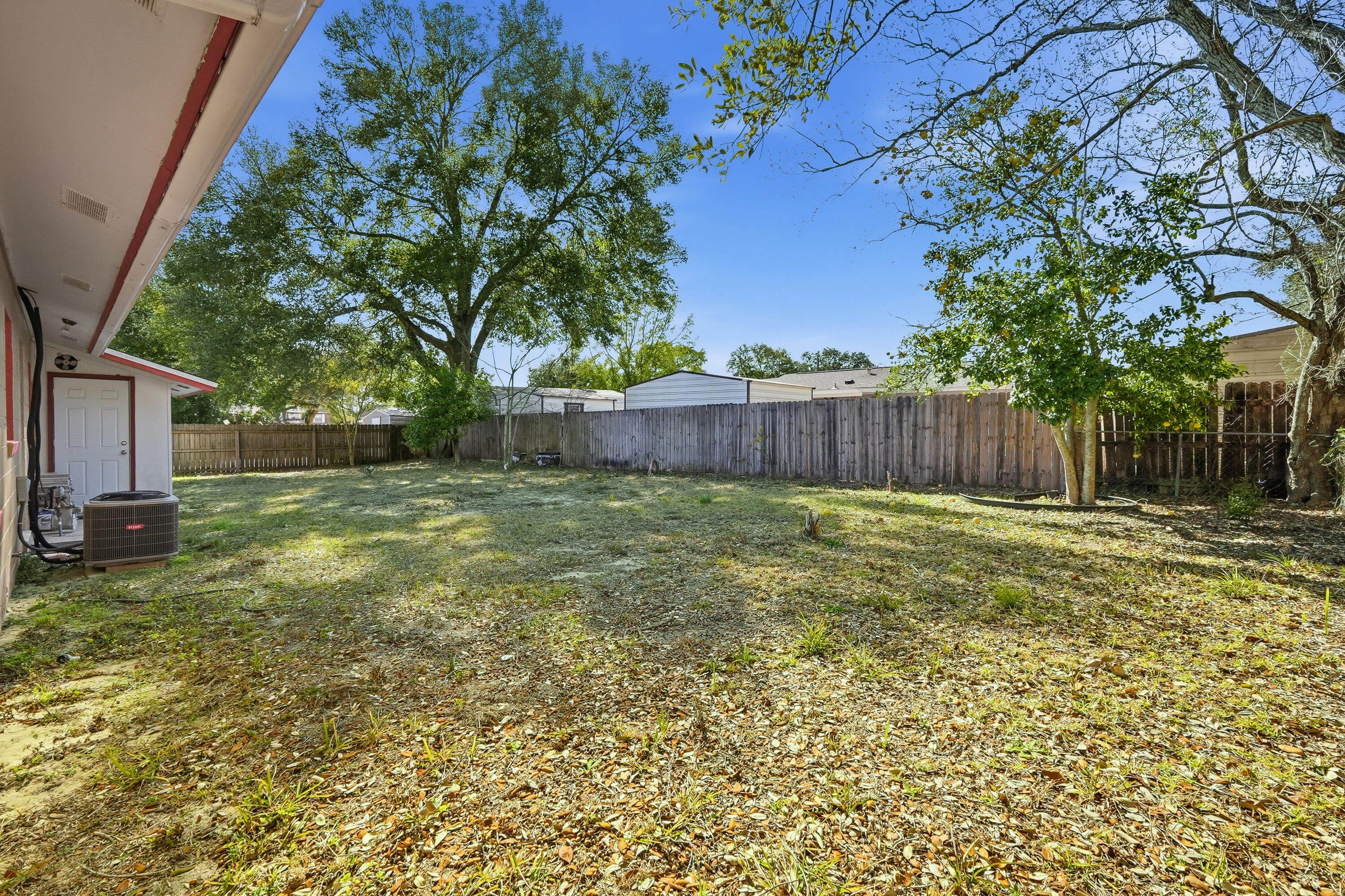63 Oak Lane Shalimar, FL 32579 - Photo 40 of 42 a view of a backyard with large tree and wooden fence
