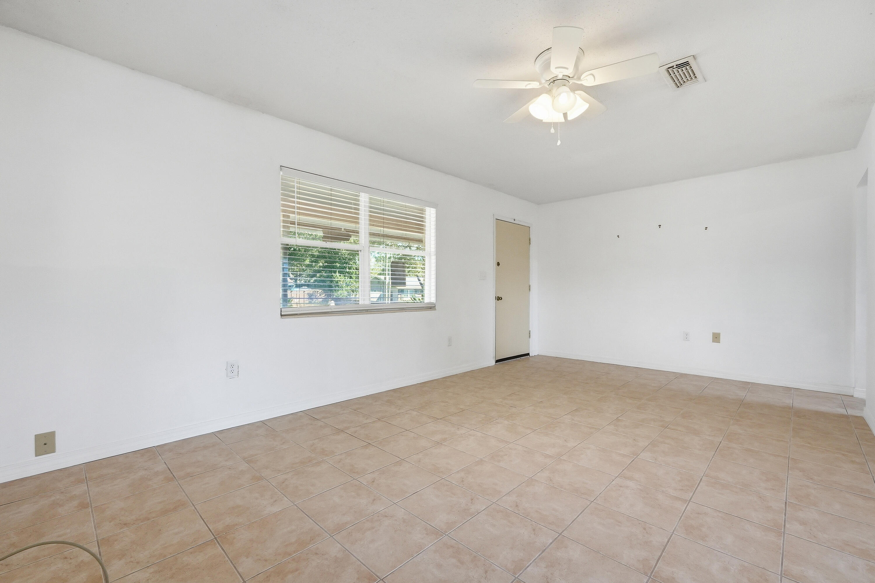 63 Oak Lane Shalimar, FL 32579 - Photo 6 of 42 an empty room with windows and ceiling fan