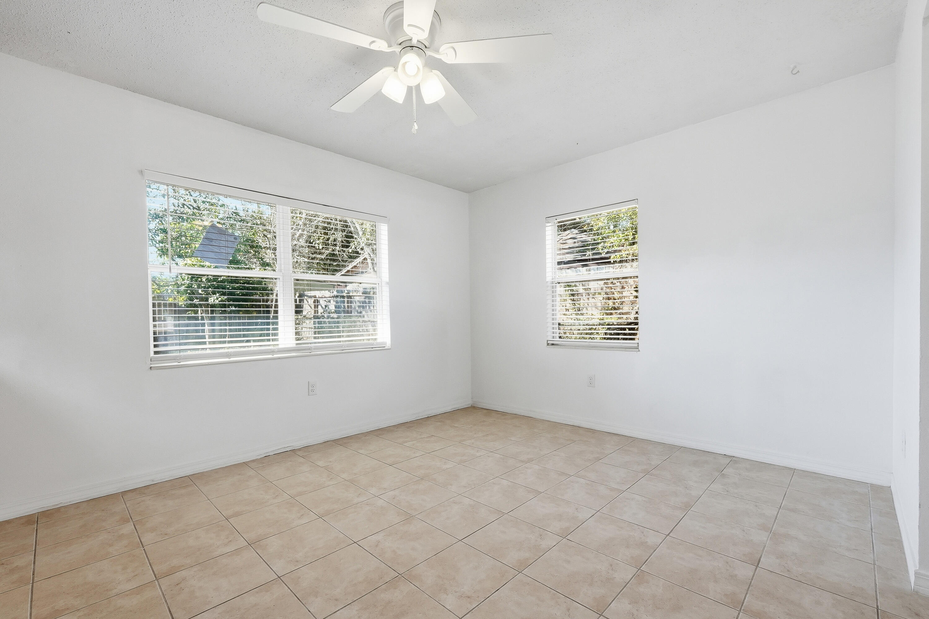 63 Oak Lane Shalimar, FL 32579 - Photo 9 of 42 an empty room with windows and fan