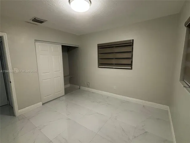 a view of an empty room with a bathroom