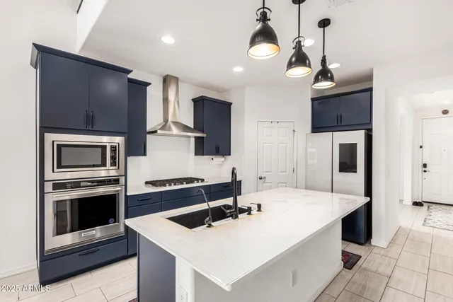 a kitchen with a stove a sink and a refrigerator