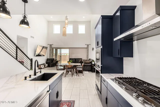 a kitchen with granite countertop a stove and a sink