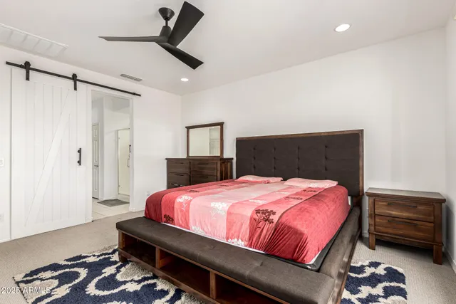 a bedroom with a bed and a mirror