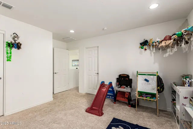 a bedroom with furniture and wooden floor
