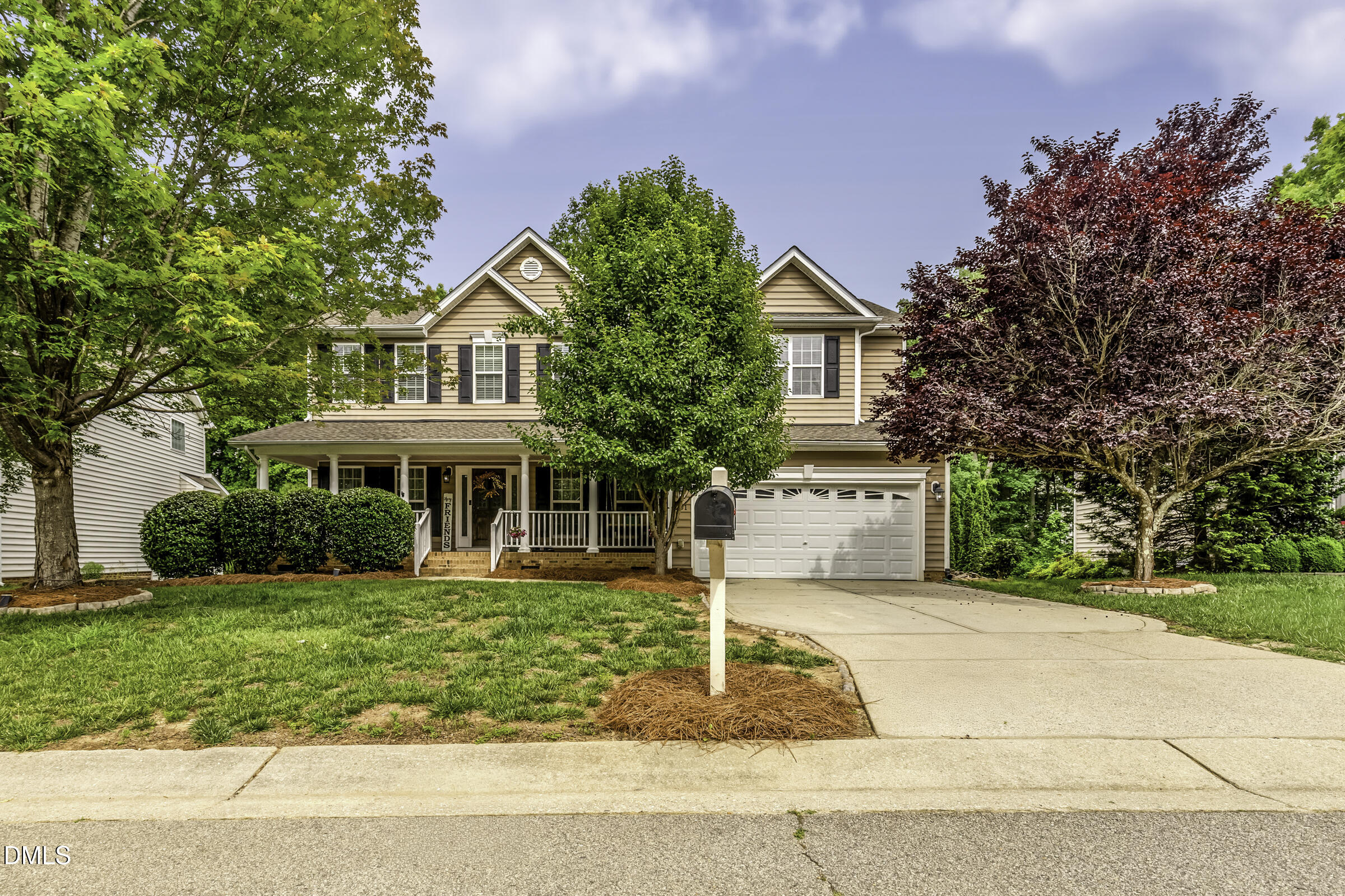 201 Quarryrock Road Holly Springs, NC 27540 - Photo 1 of 34 a front view of a house with a garden and trees