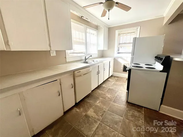 a view of a kitchen with a sink and cabinets