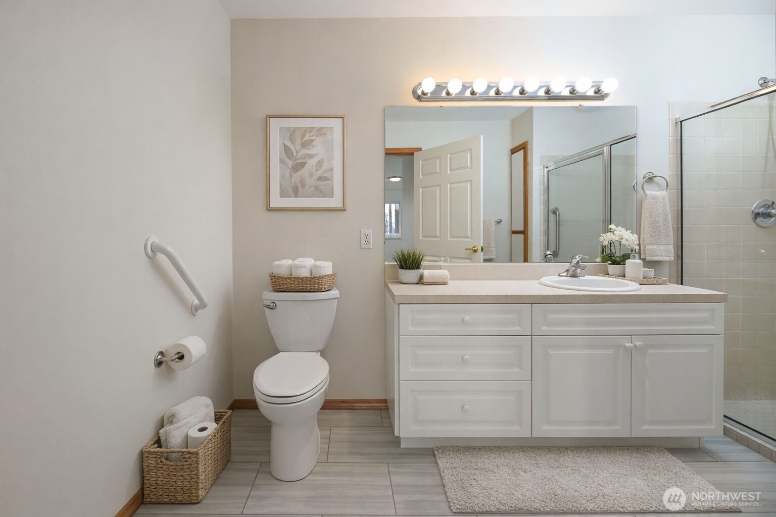 509 1st Street, Unit 104 Snohomish, WA 98290 - Photo 15 of 33 a bathroom with a sink a toilet and a large mirror